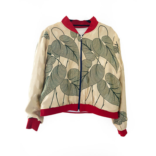 Cream bomber jacket with green leaf pattern and red accents on a white background