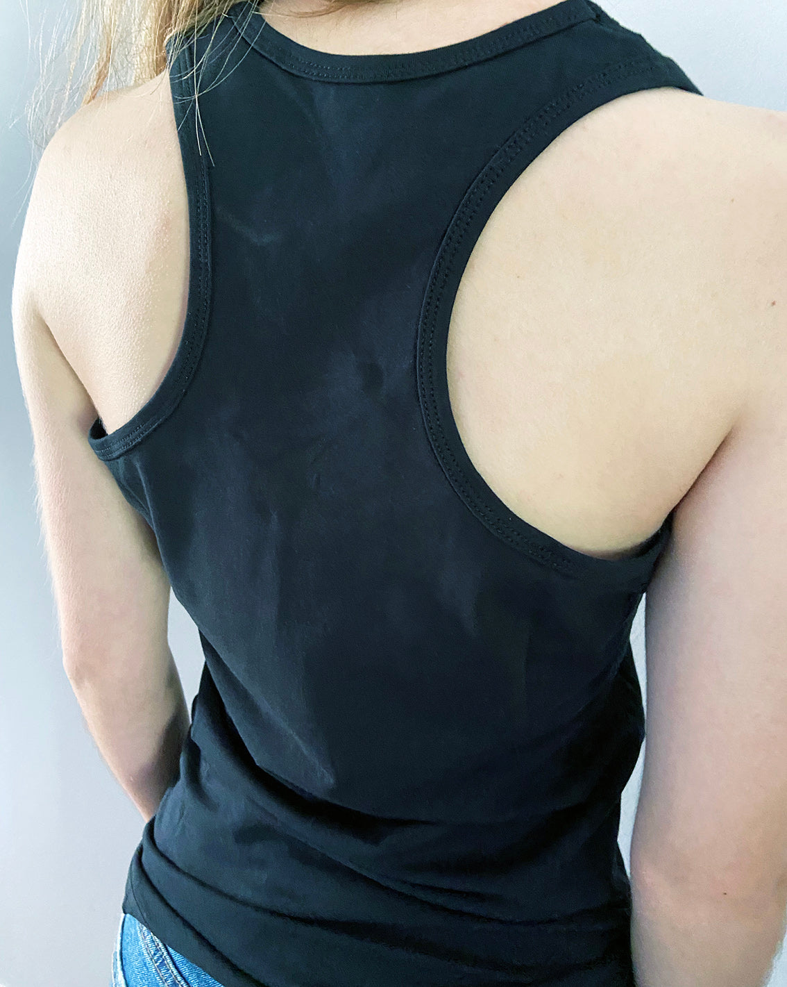 Close up of the back of a black razor back vest