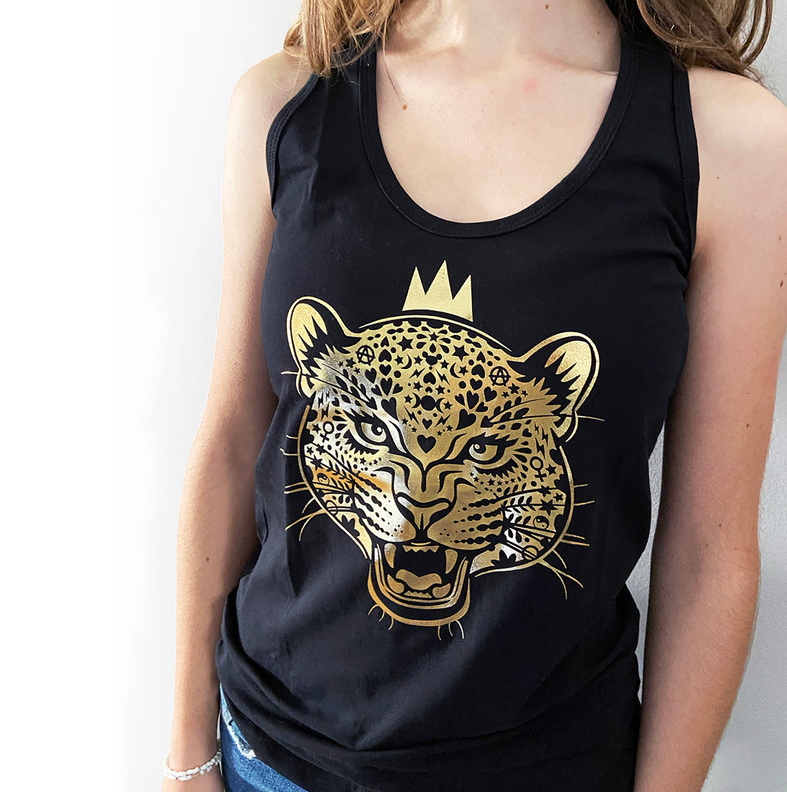 Black vest close up with gold foil print of leopard queen