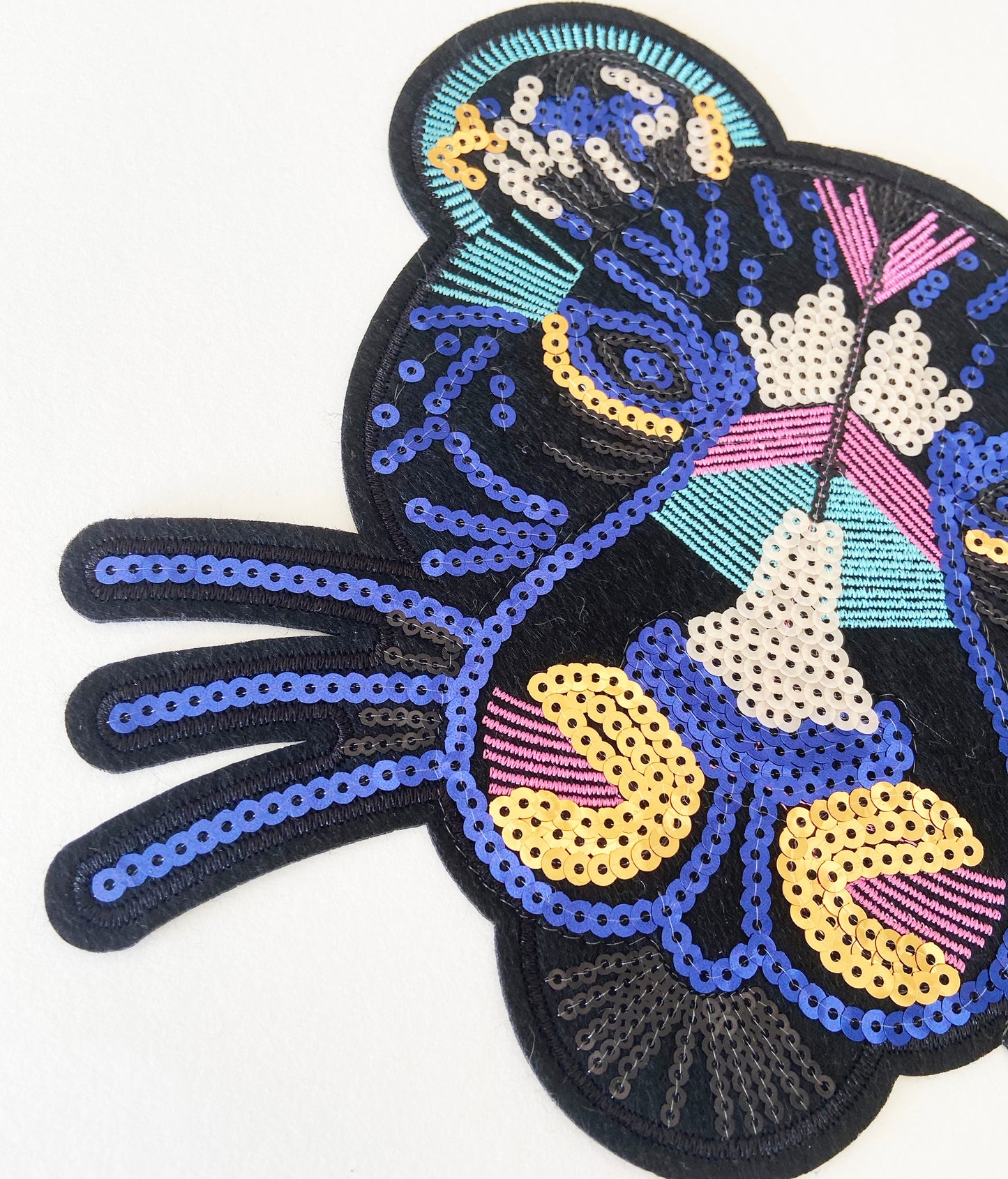 Colourful sequin leopard patch on a white background
