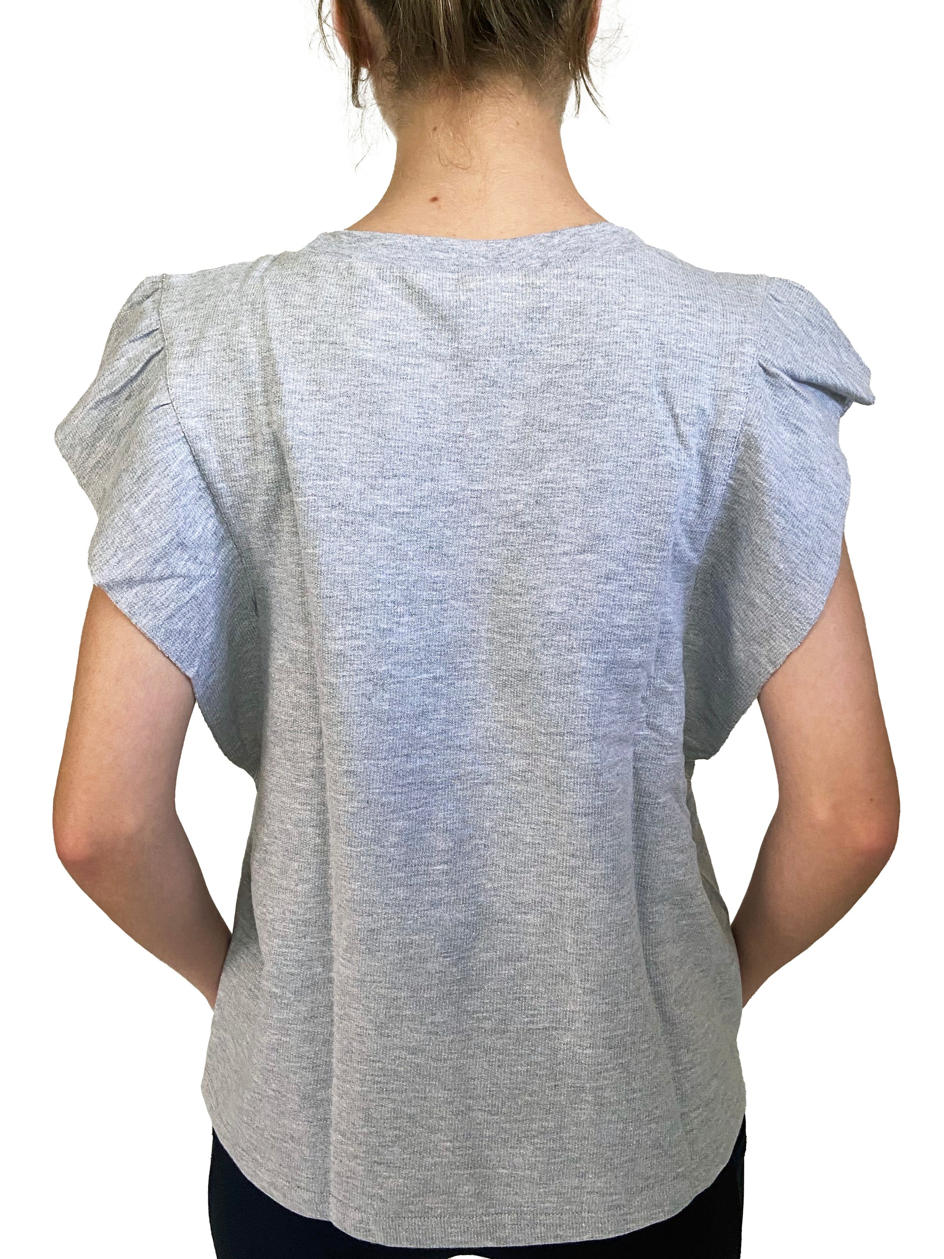 Person wearing a gray short-sleeve top on a white background