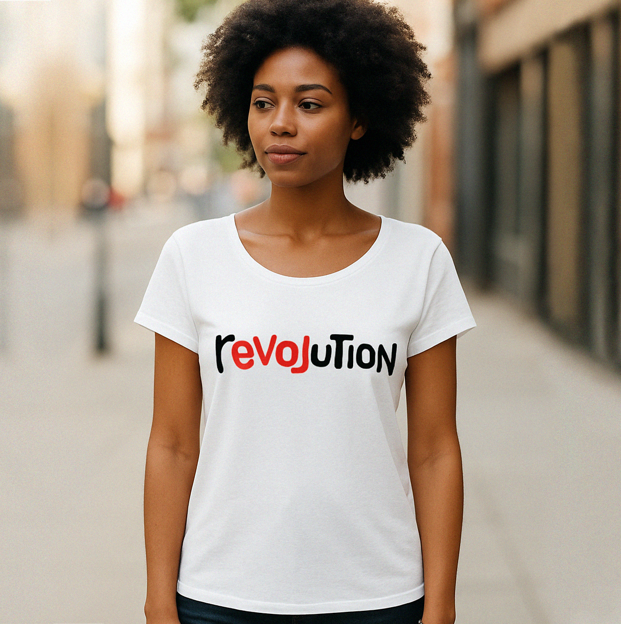 Woman wearing a white t-shirt with 'revoLution' printed on it, standing outdoors.