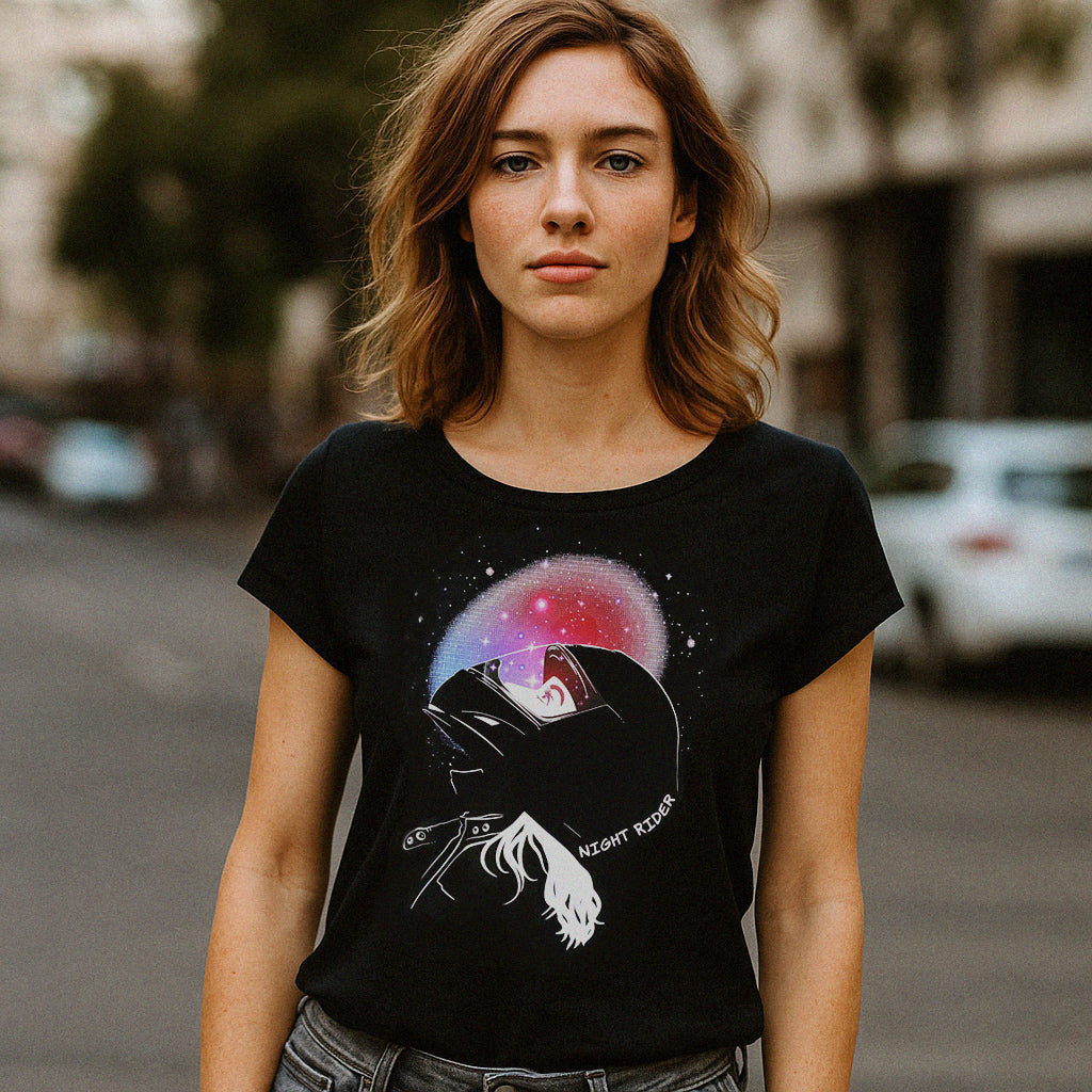 Woman wearing a black t-shirt with a graphic design on a street background