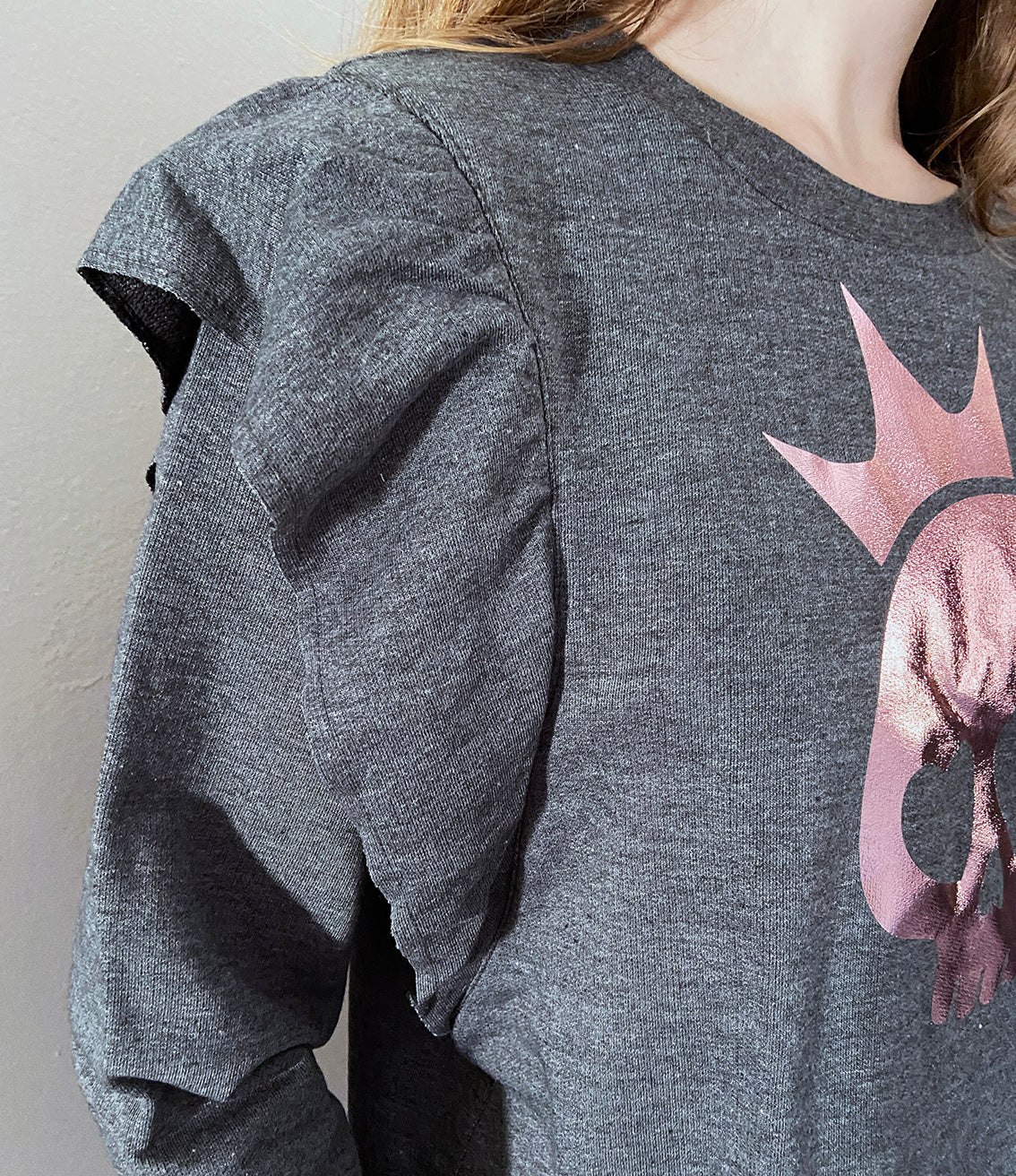 close up of the sleeve frill detail on charcoal shirt.