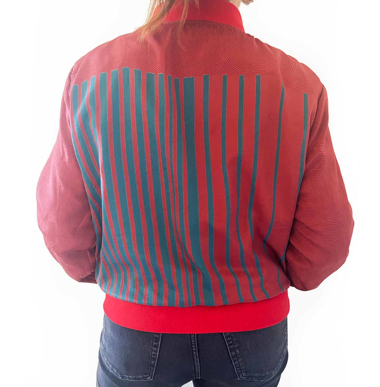 Red jacket with blue and gray striped pattern on a white background