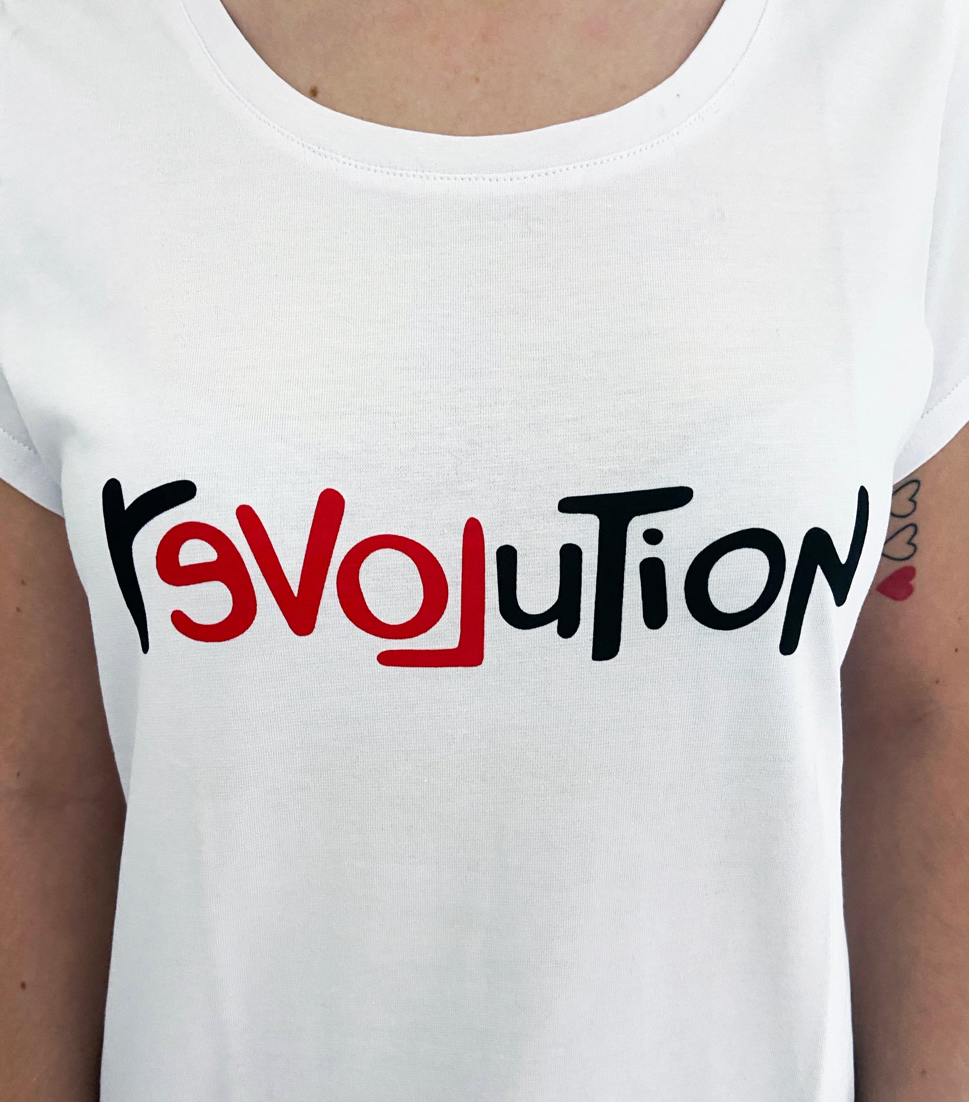 White tank top with 'Revolution' printed in black and red on a white background