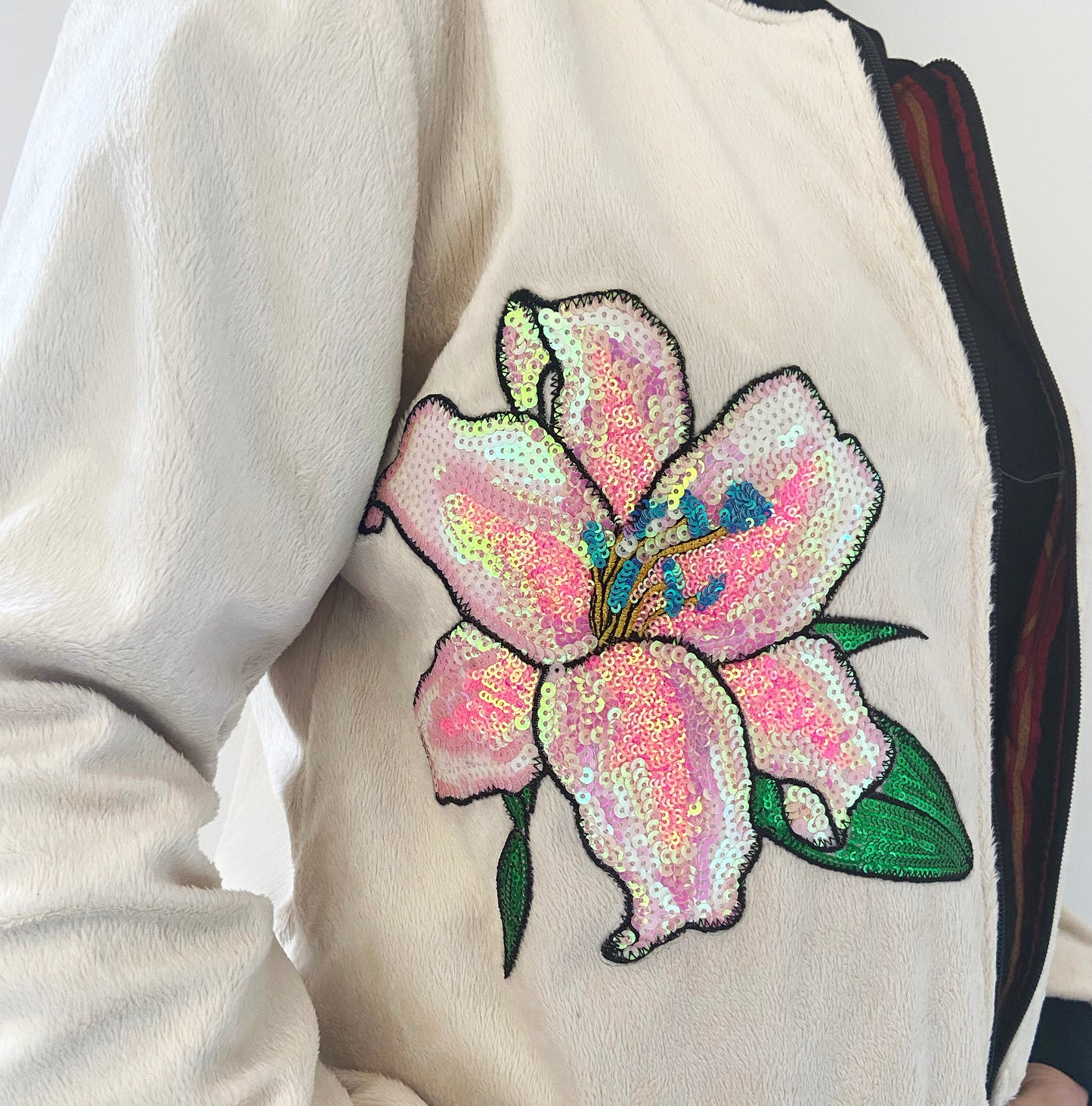 Sequined flower patch on a white jacket