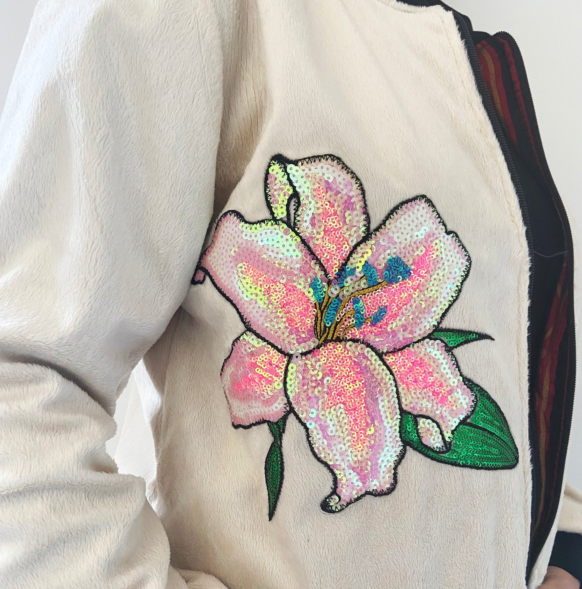 Sequined flower patch on a white jacket