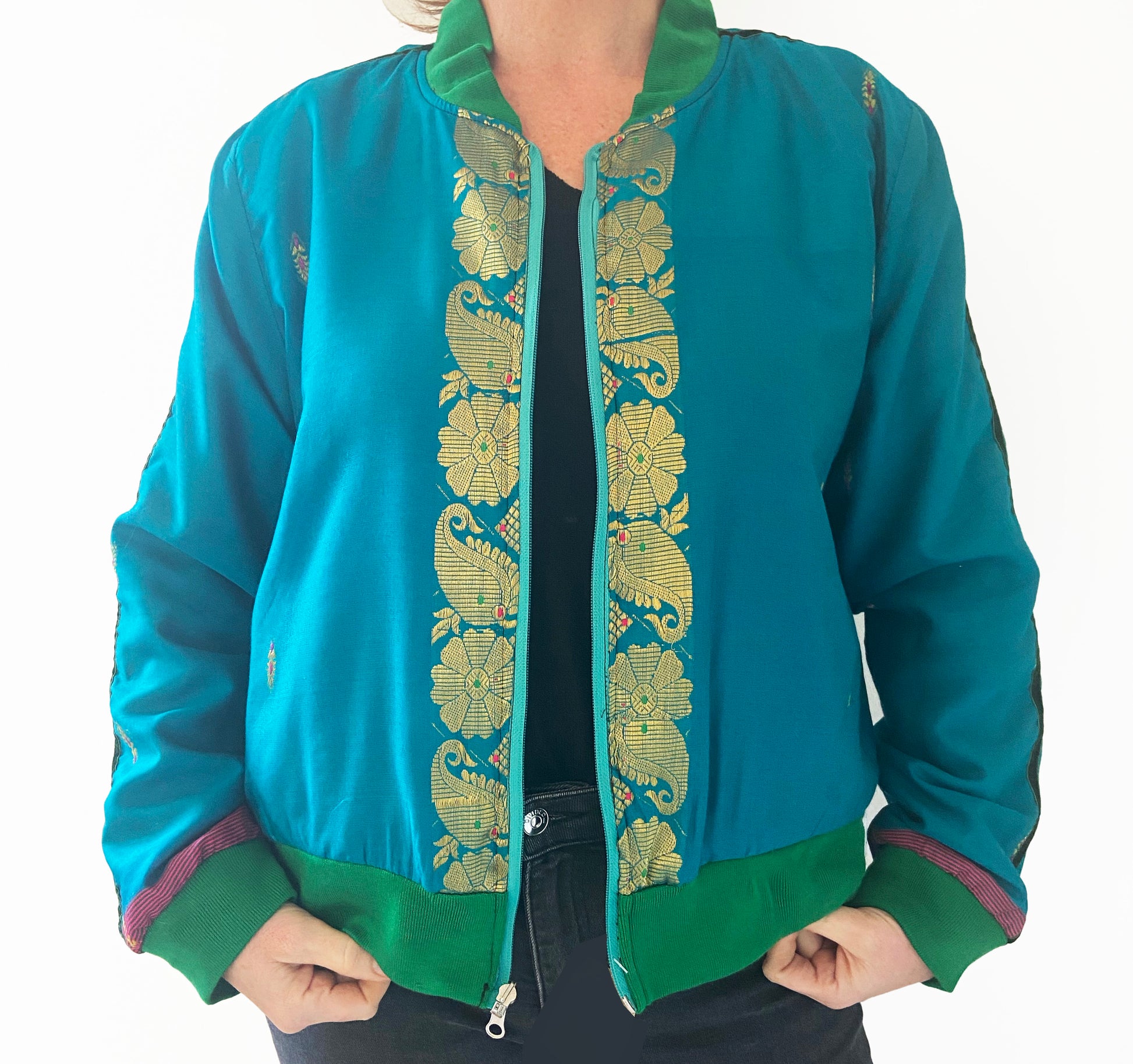 Teal jacket with gold embroidery on a white background