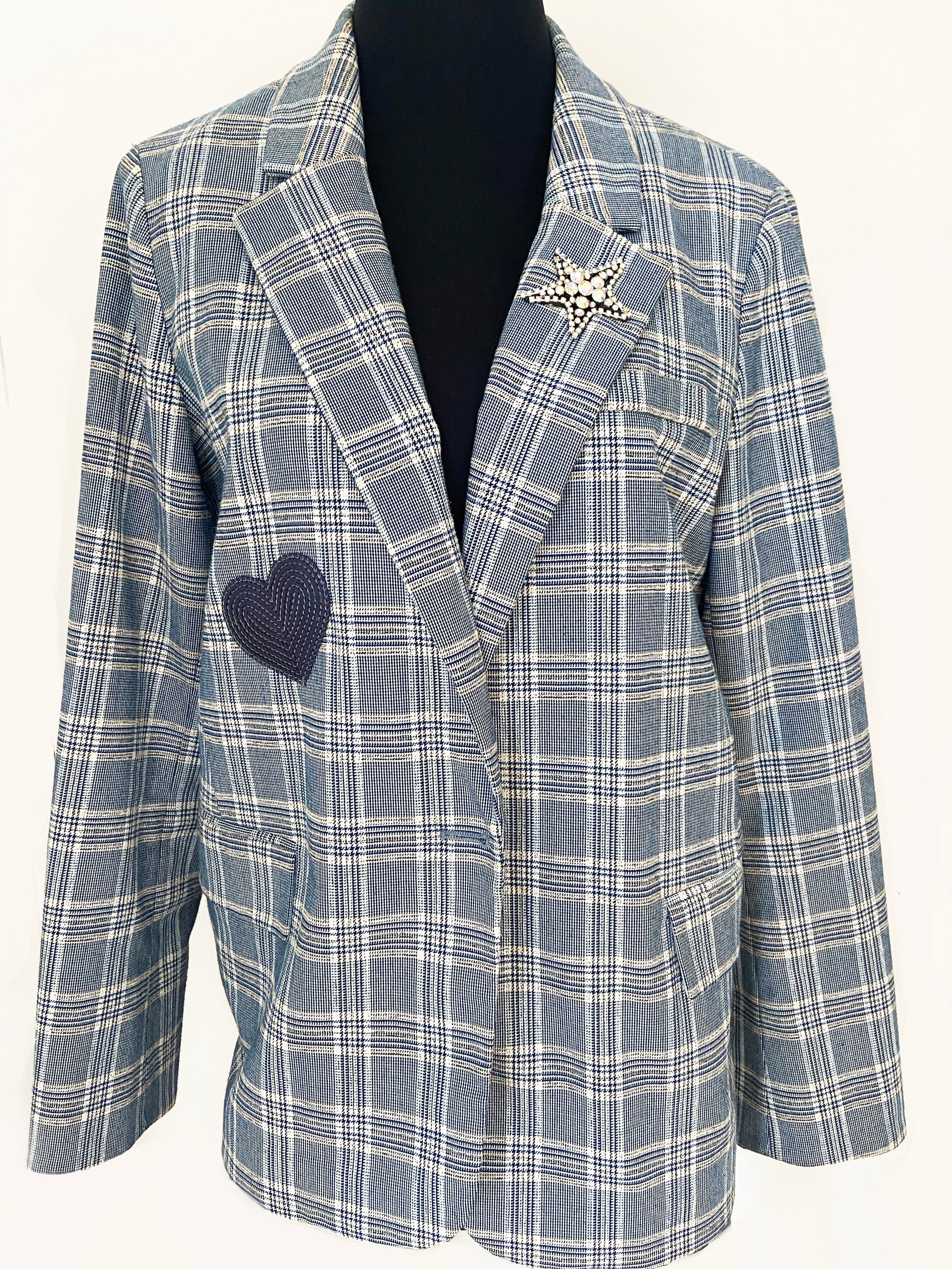 Blue and white checkered blazer with a heart-shaped patch on a white background