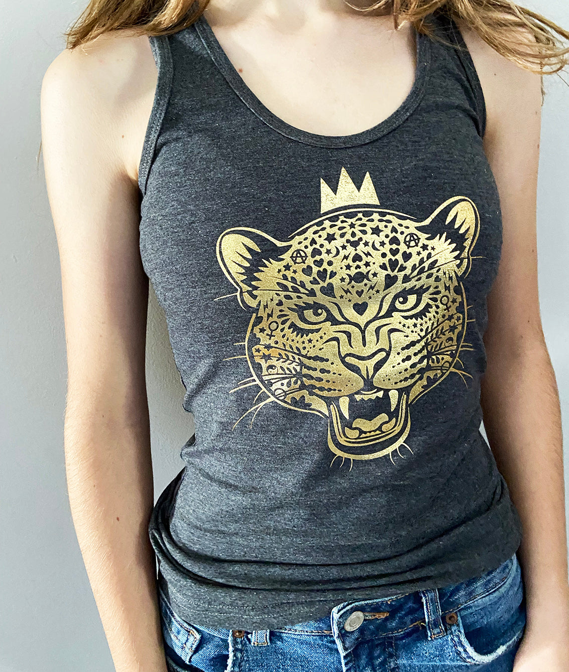 close up of a girl wearing a charcoal vest with gold leopard print