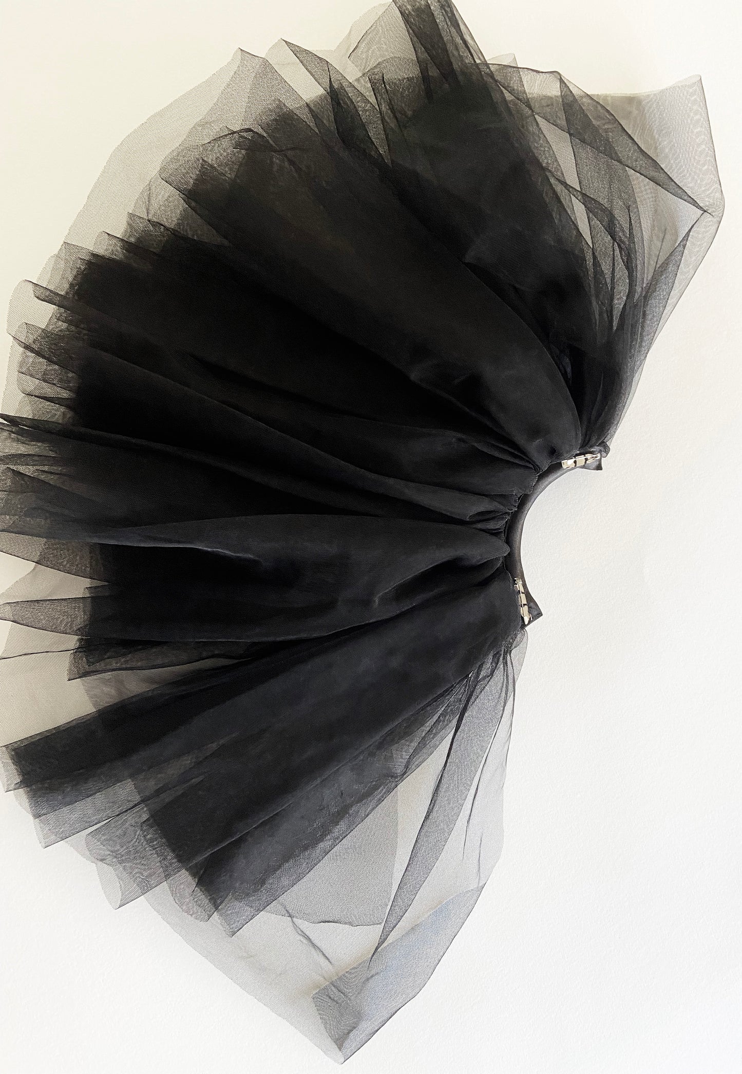 Separate black tulle sleeve on a white background