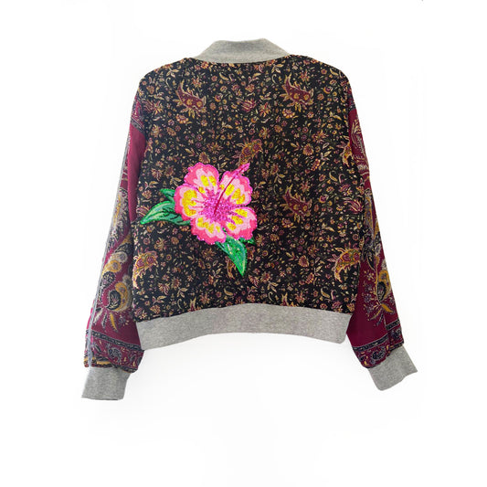 Floral patterned jacket with a pink flower design on a white background