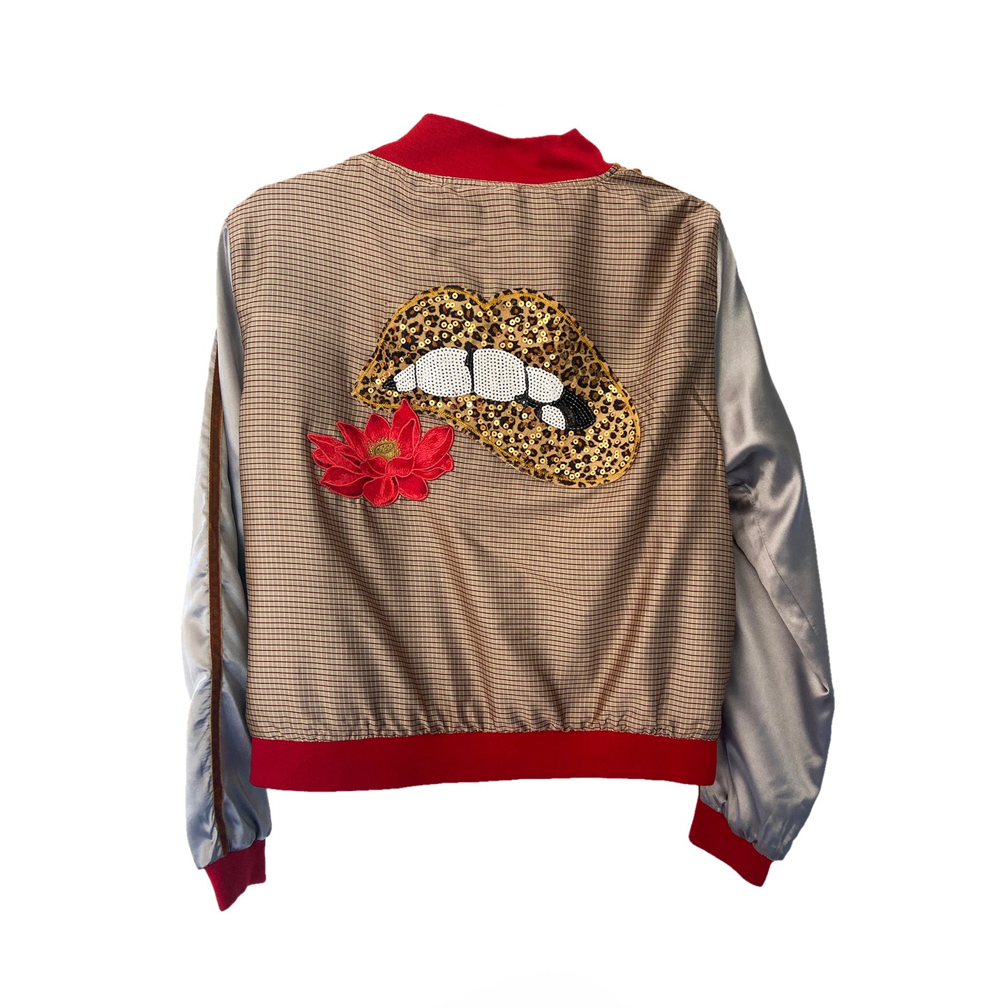 Back view of a jacket with a leopard print lips patch and embroidered red flower on a beige background
