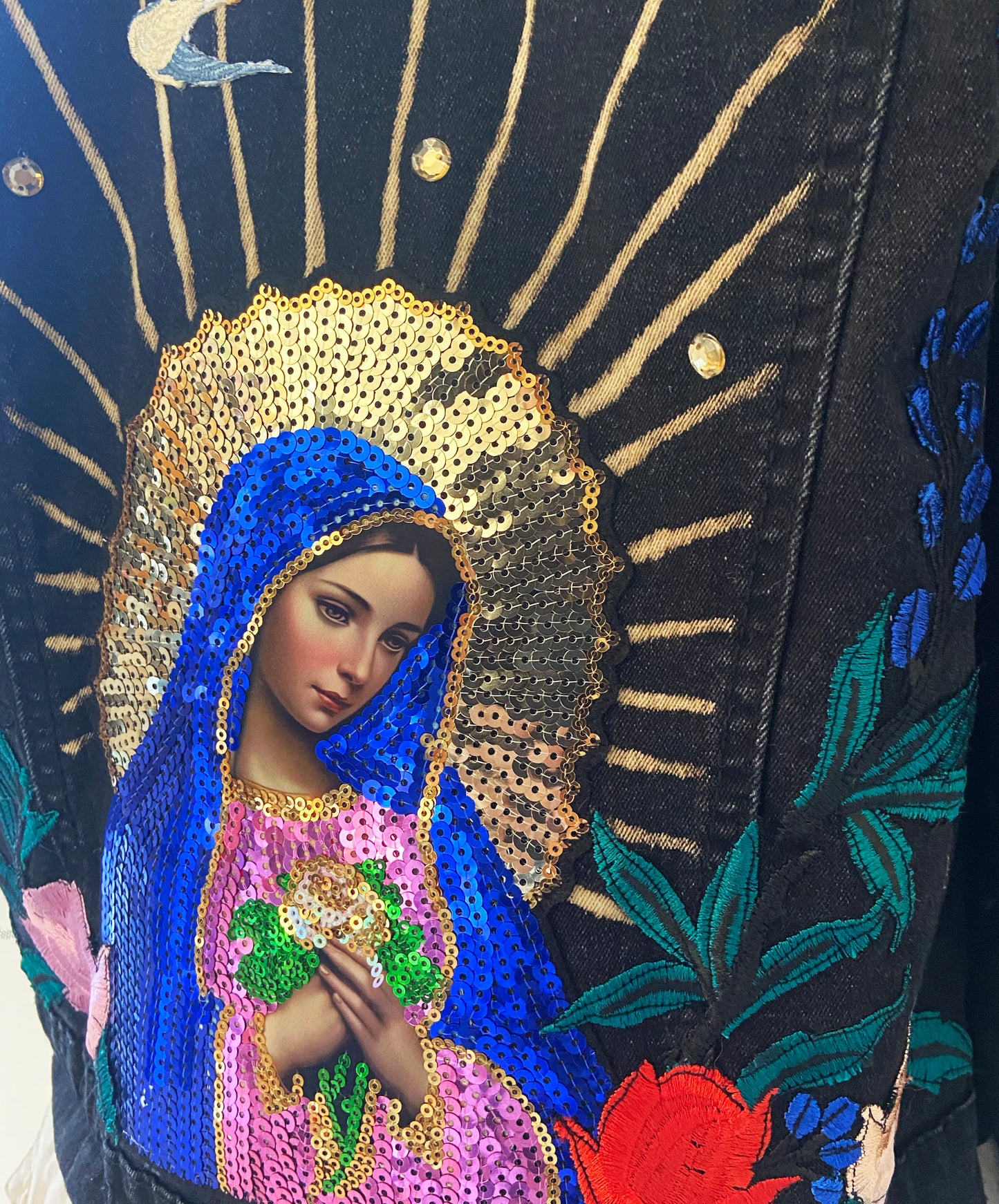 Decorative piece with a religious icon, blue and gold robe, and floral patterns.