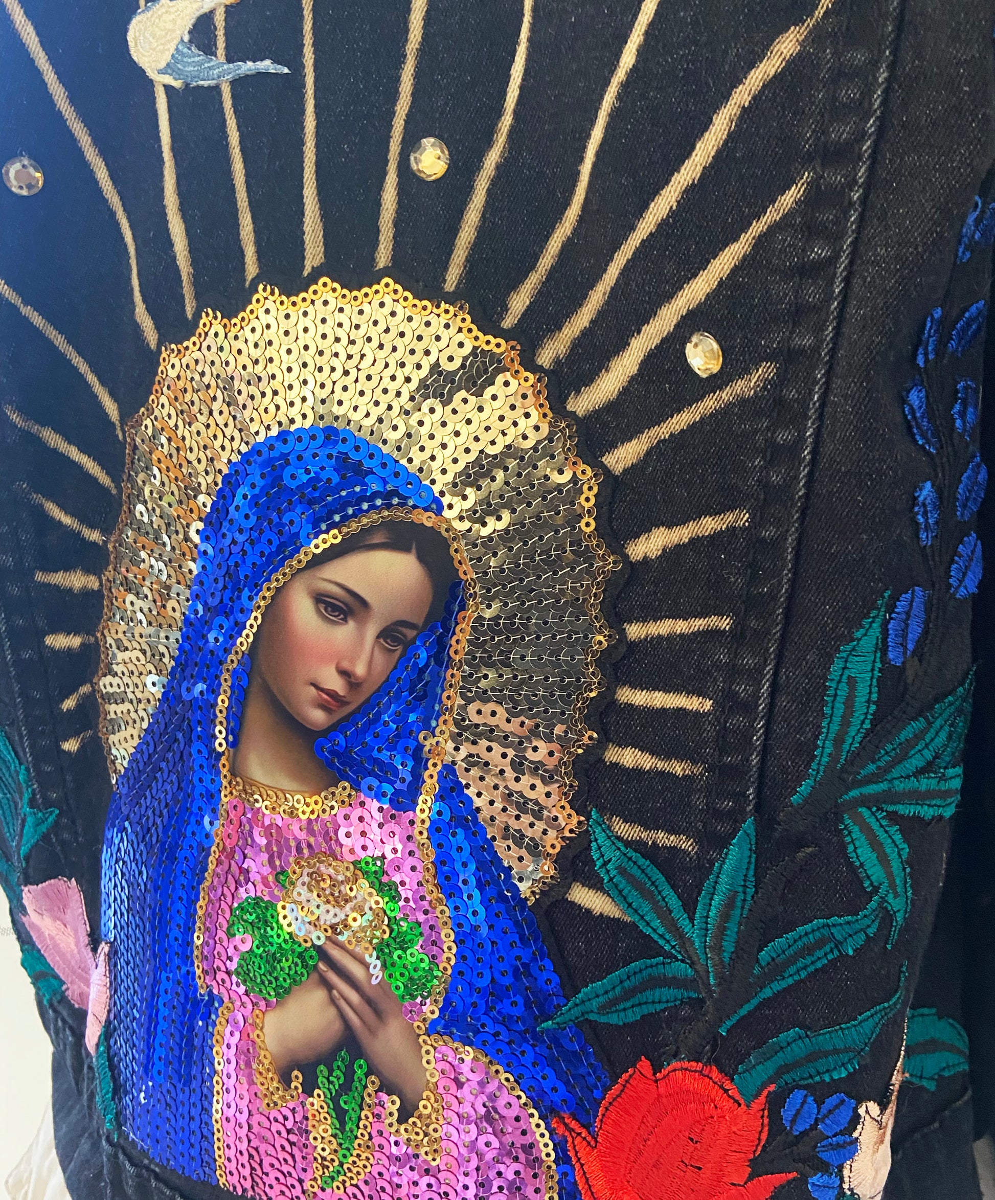 Decorative piece with a religious icon, blue and gold robe, and floral patterns.