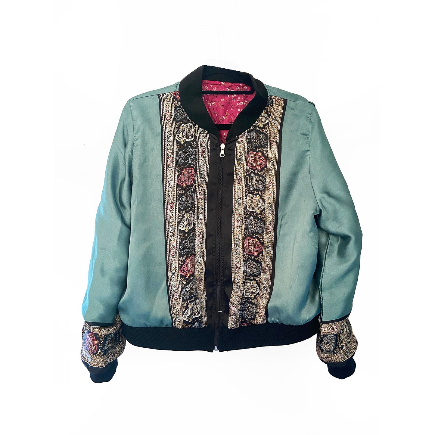 Teal blue silk jacket with intricate patterns on a white background