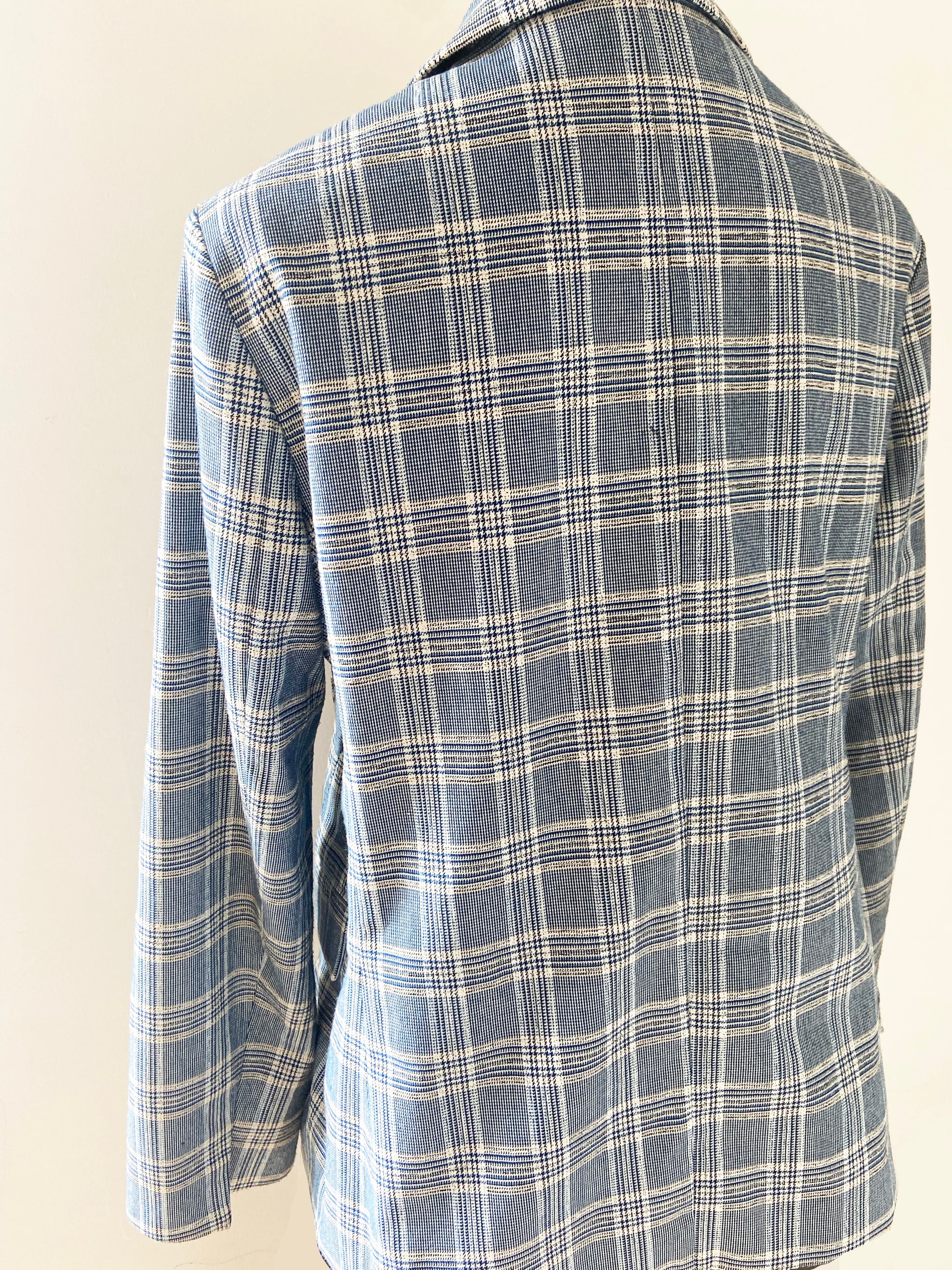 Blue and white plaid jacket on a light beige background